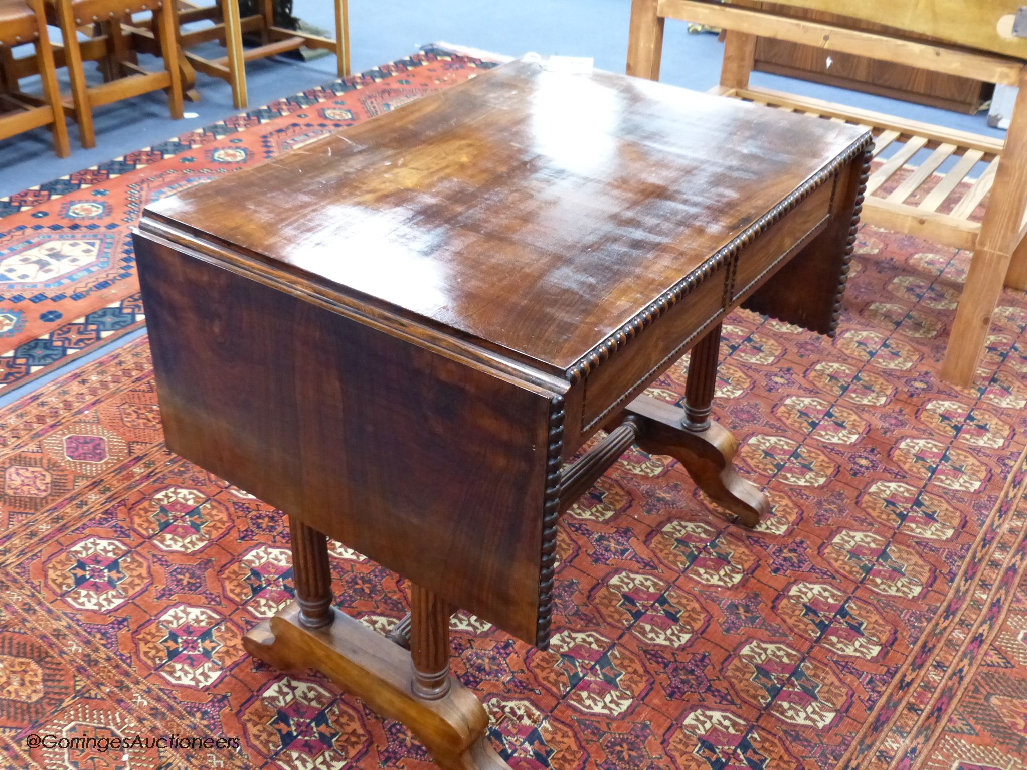 A 19th-century French rosewood sofa table, 86 cm wide with the leaves down, 61.5 cm deep, 75 cm high